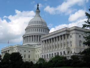 The U.S. Capitol dome against a backdrop of clouds and blue sky