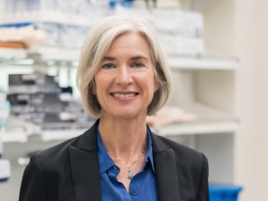 smiling woman in lab looking into camera