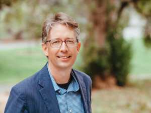 image of man in glasses smiling 