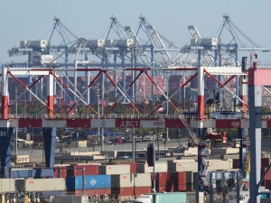 Masses of shipping containers are stacked beneath towering cranes at the busy port in Long Beach, Califonia.