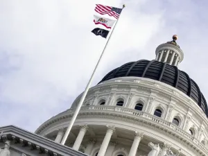 The dome of the California state capitol in Sacramento, with flags