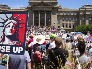 A sign with the Statue of Liberty that says "Rise Up"