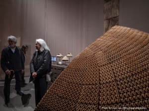 image of people standing admiring a piece of art