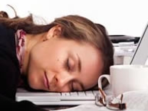 woman with head on laptop keyboard