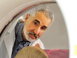 William Jagust peering into MRI machine