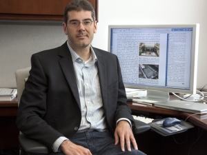 image of Jeff long sitting at his desk