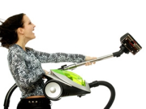 profile of woman holding a vacuum cleaner