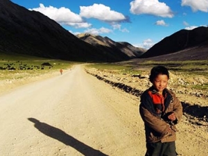 young child on mountainous roadway