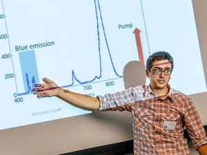 man standing in front of projection of graphs