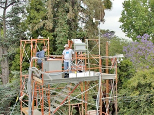 two men standing on platform with test equipment